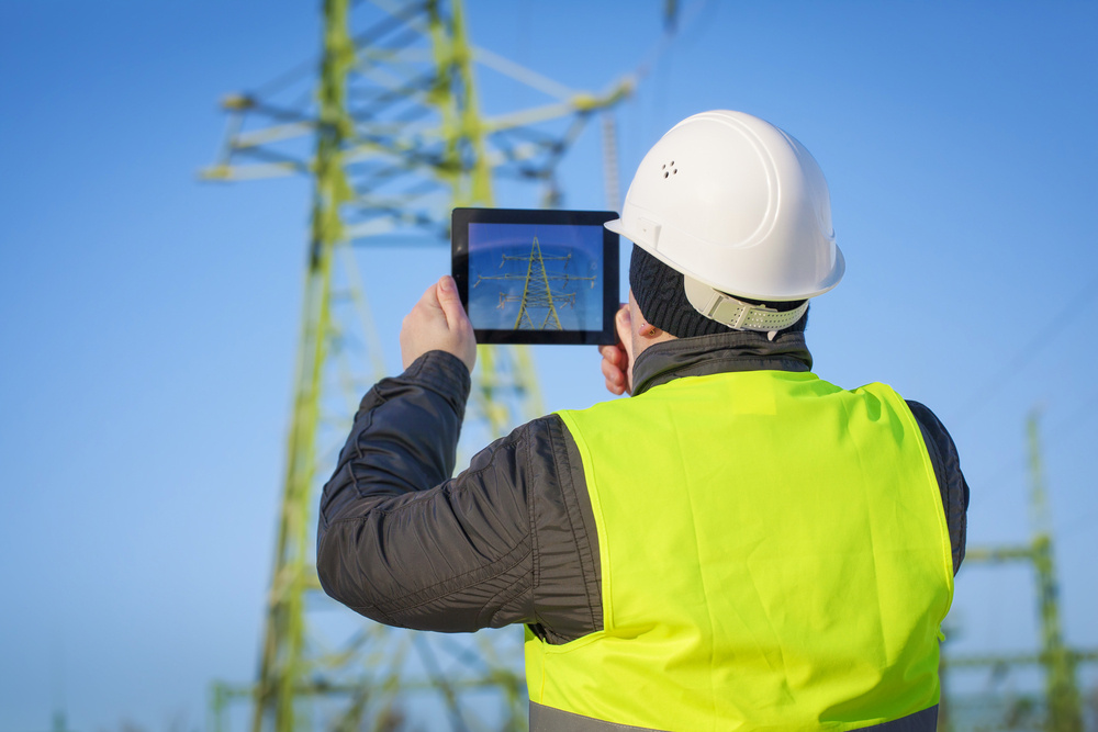 Field worker outdoors using AEX Field Squared enterprise asset management on mobile device
