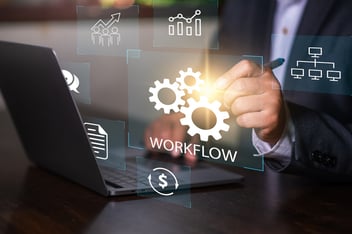 visual of a laptop with a workflow and someone's hand choosing the visual.