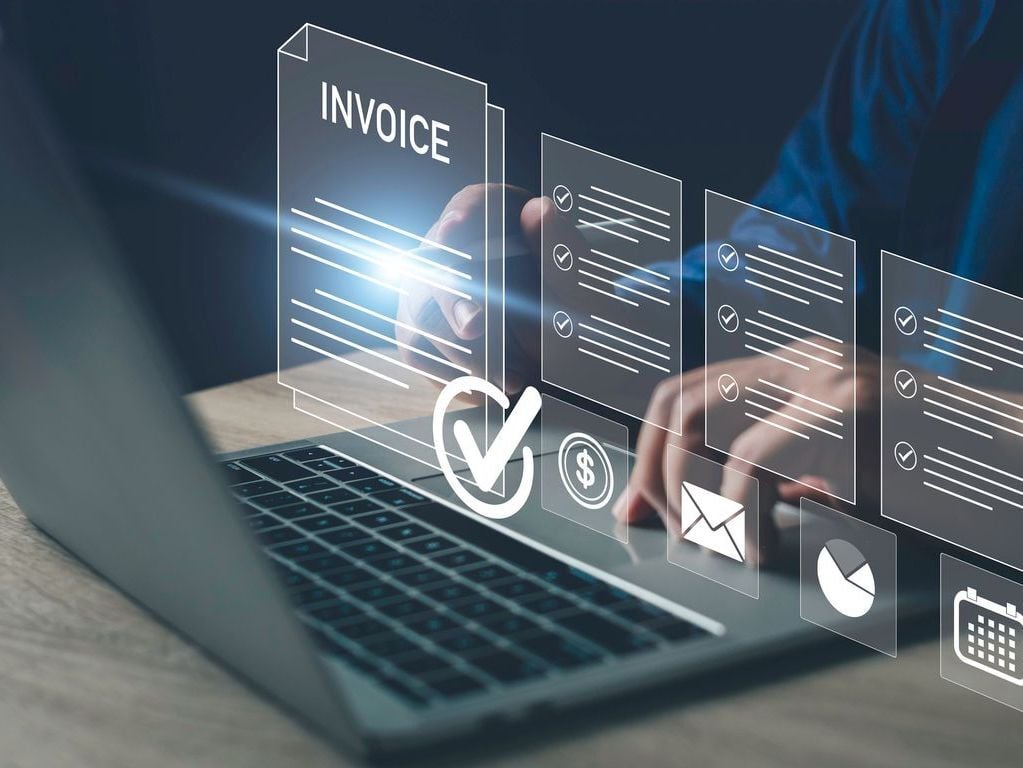 man on keyboard with invoicing process checked off